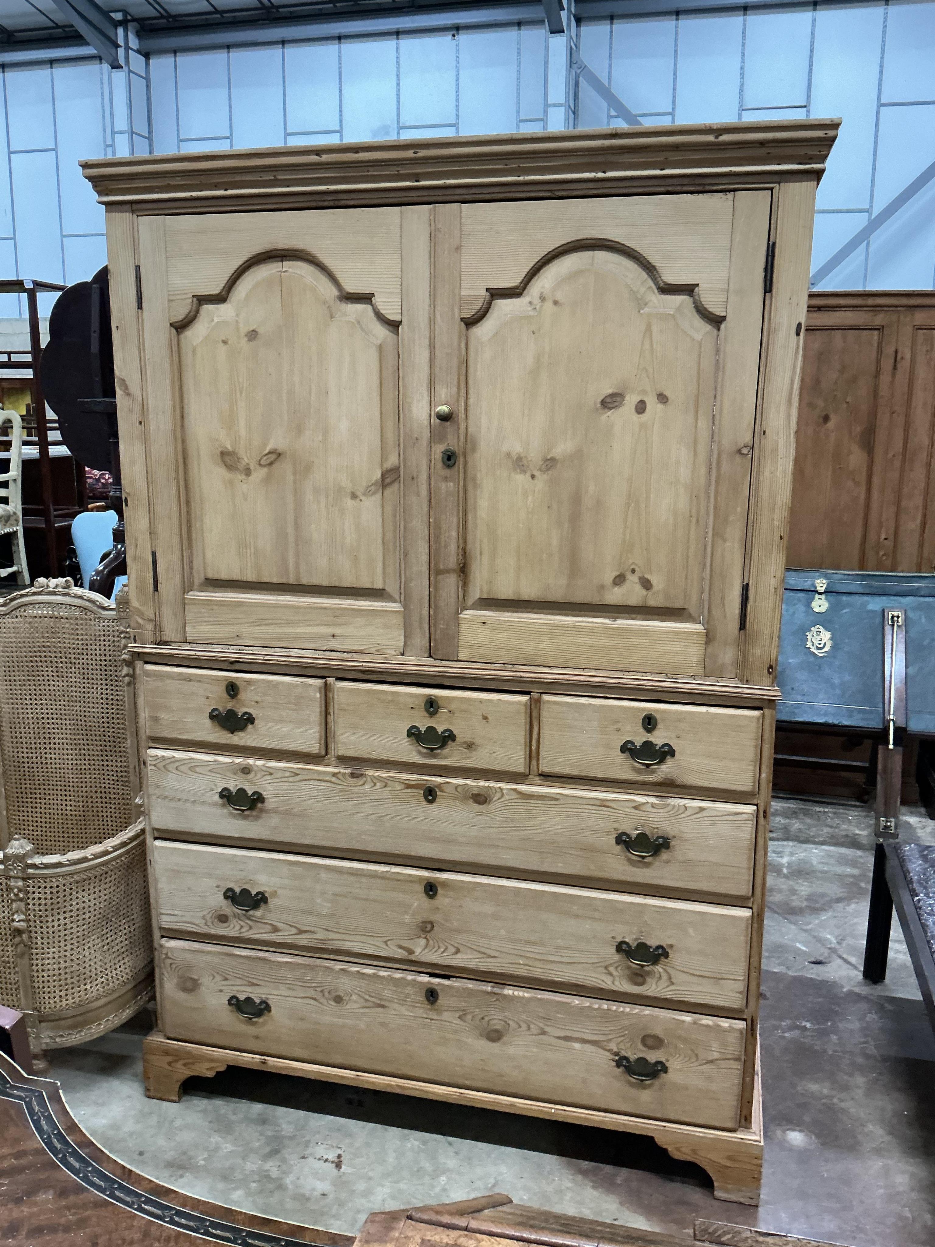 An early 19th century pine two part press cupboard, width 125cm, depth 54cm, height 191cm